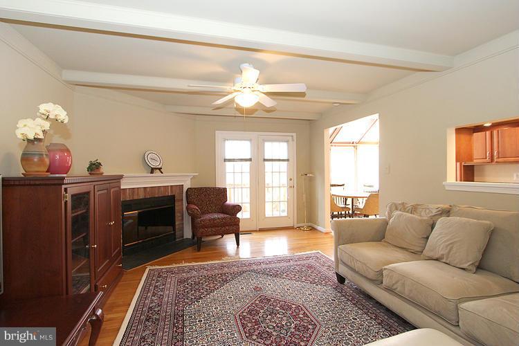 10922 Brewer House Road Rockville, MD 20852 - Photo 8 of 27 a living room with furniture a chandelier and a rug