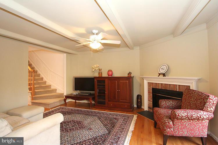 10922 Brewer House Road Rockville, MD 20852 - Photo 9 of 27 a living room with furniture a fireplace and a flat screen tv