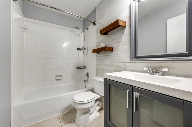a bathroom with a sink toilet vanity and shower