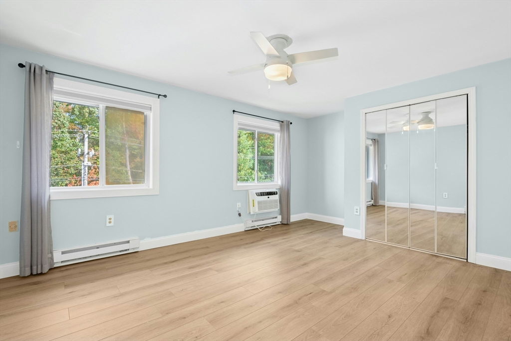 10 Erick Road, Unit 34 Mansfield, MA 02048 - Photo 13 of 24 an empty room with wooden floor and windows