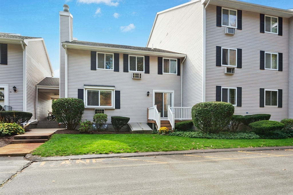 10 Erick Road, Unit 34 Mansfield, MA 02048 - Photo 2 of 24 a front view of a house with a yard and a garage
