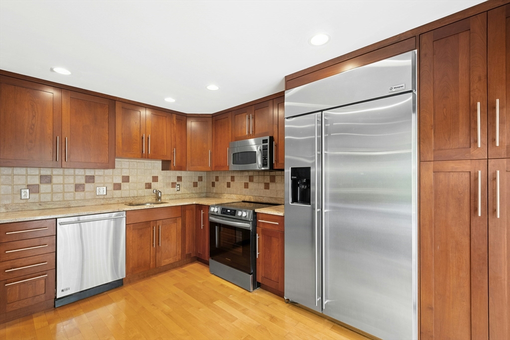 10 Erick Road, Unit 34 Mansfield, MA 02048 - Photo 7 of 24 a kitchen with stainless steel appliances granite countertop a refrigerator and a sink