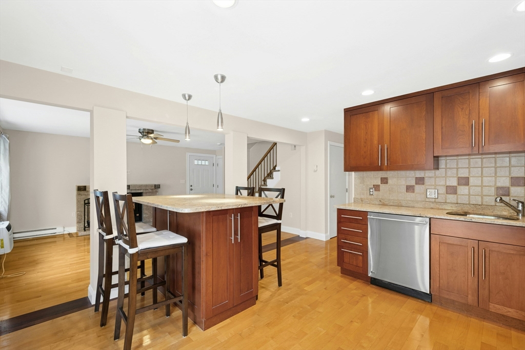 10 Erick Road, Unit 34 Mansfield, MA 02048 - Photo 9 of 24 a kitchen with table chairs sink and cabinets