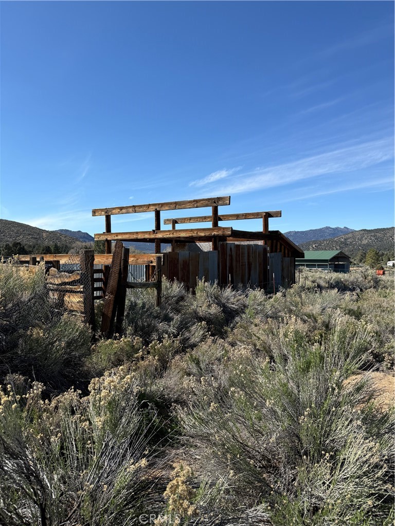 0 310-240-001 Kennedy Meadows Road Inyokern, CA 93527 - Photo 13 of 20 a view of a dry yard with wooden fence