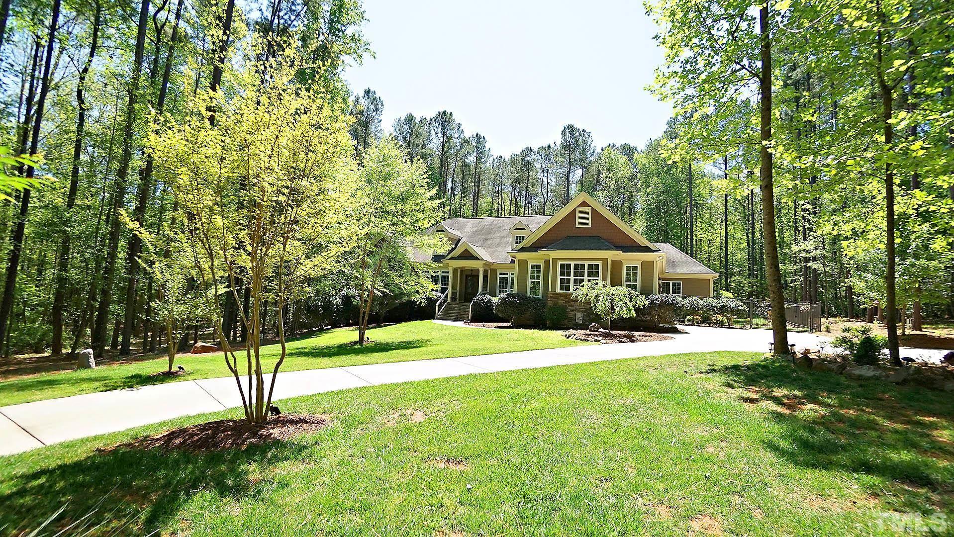 275 Hawfields Drive Pittsboro, NC 27312 - Photo 43 of 44 a house with green field in front of it