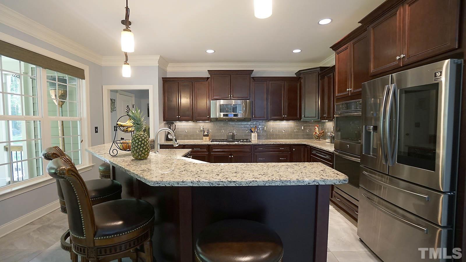 275 Hawfields Drive Pittsboro, NC 27312 - Photo 13 of 44 a kitchen with stainless steel appliances granite countertop a sink refrigerator and cabinets