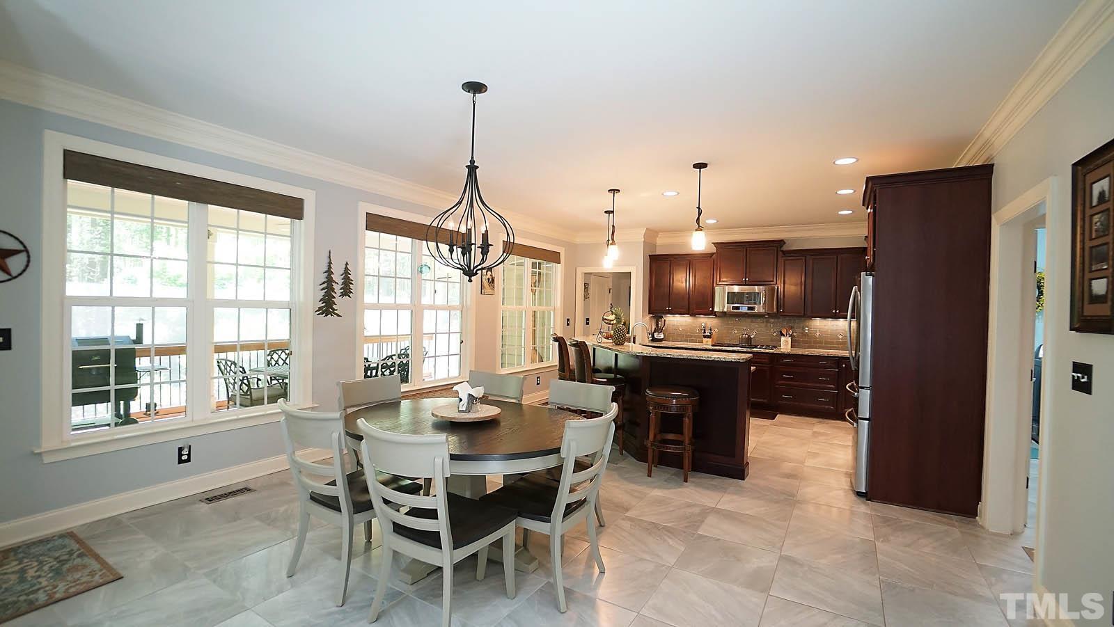 275 Hawfields Drive Pittsboro, NC 27312 - Photo 14 of 44 a view of a dining room and livingroom with furniture wooden floor a chandelier
