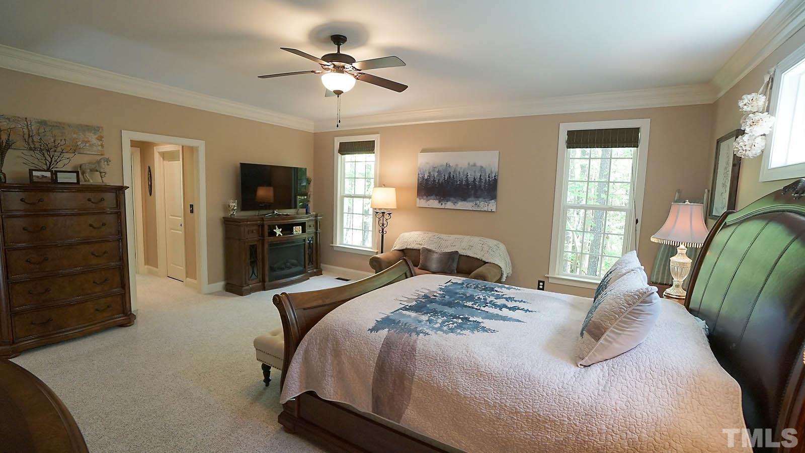 275 Hawfields Drive Pittsboro, NC 27312 - Photo 19 of 44 a bedroom with a bed a television and dresser