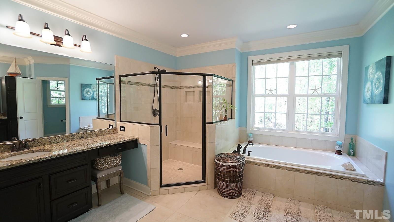 275 Hawfields Drive Pittsboro, NC 27312 - Photo 21 of 44 a spacious bathroom with a granite countertop tub sink shower and mirror