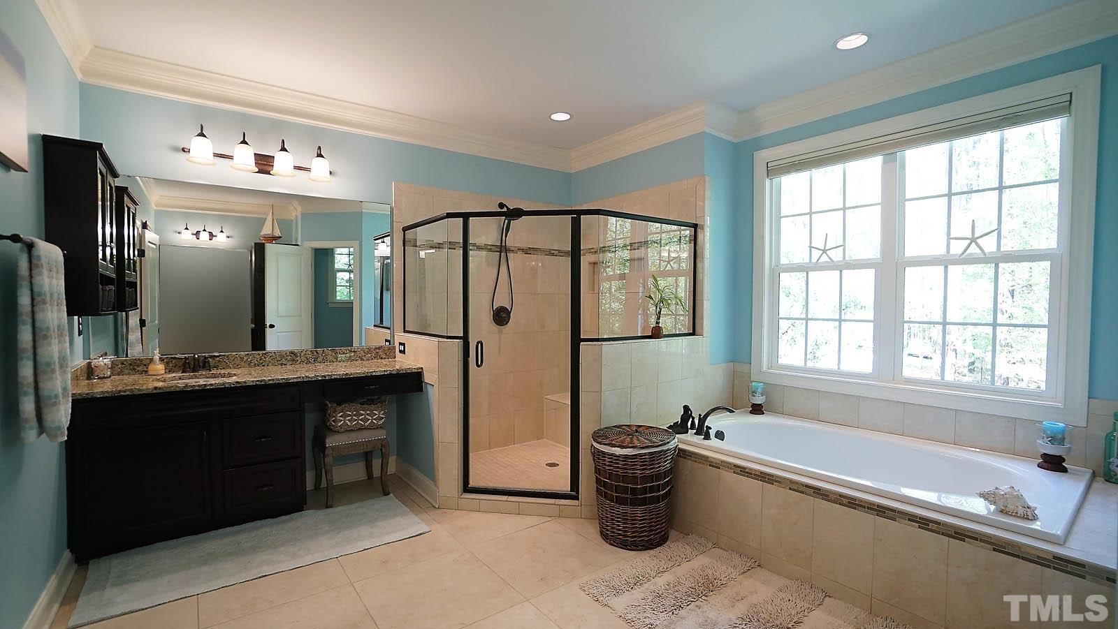 275 Hawfields Drive Pittsboro, NC 27312 - Photo 22 of 44 a spacious bathroom with a tub sink shower and mirror