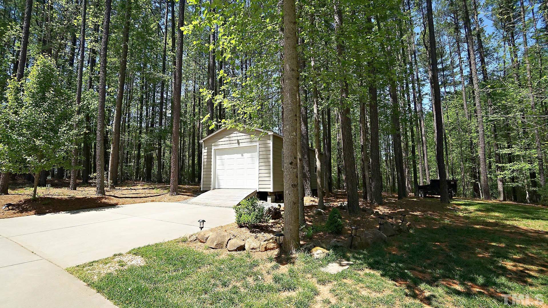 275 Hawfields Drive Pittsboro, NC 27312 - Photo 24 of 44 a view of a house with backyard and trees