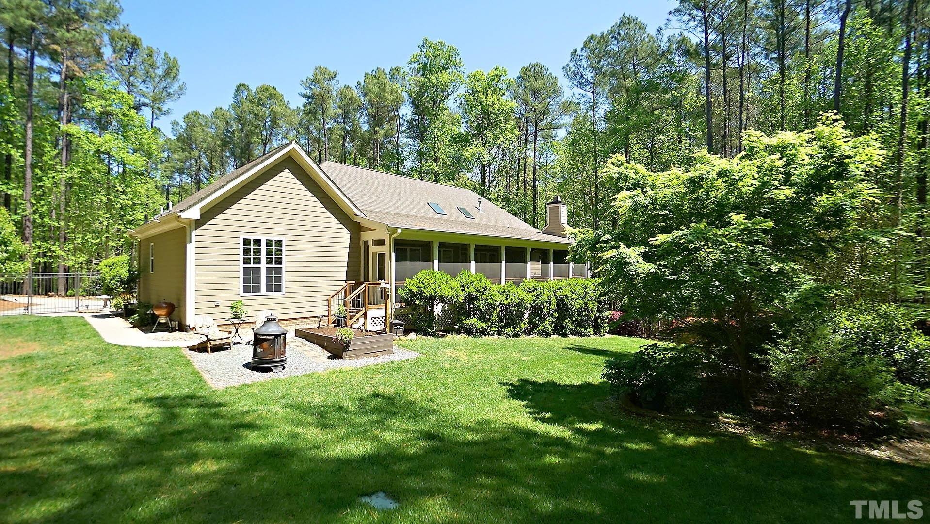 275 Hawfields Drive Pittsboro, NC 27312 - Photo 25 of 44 a view of a house with backyard sitting area and garden