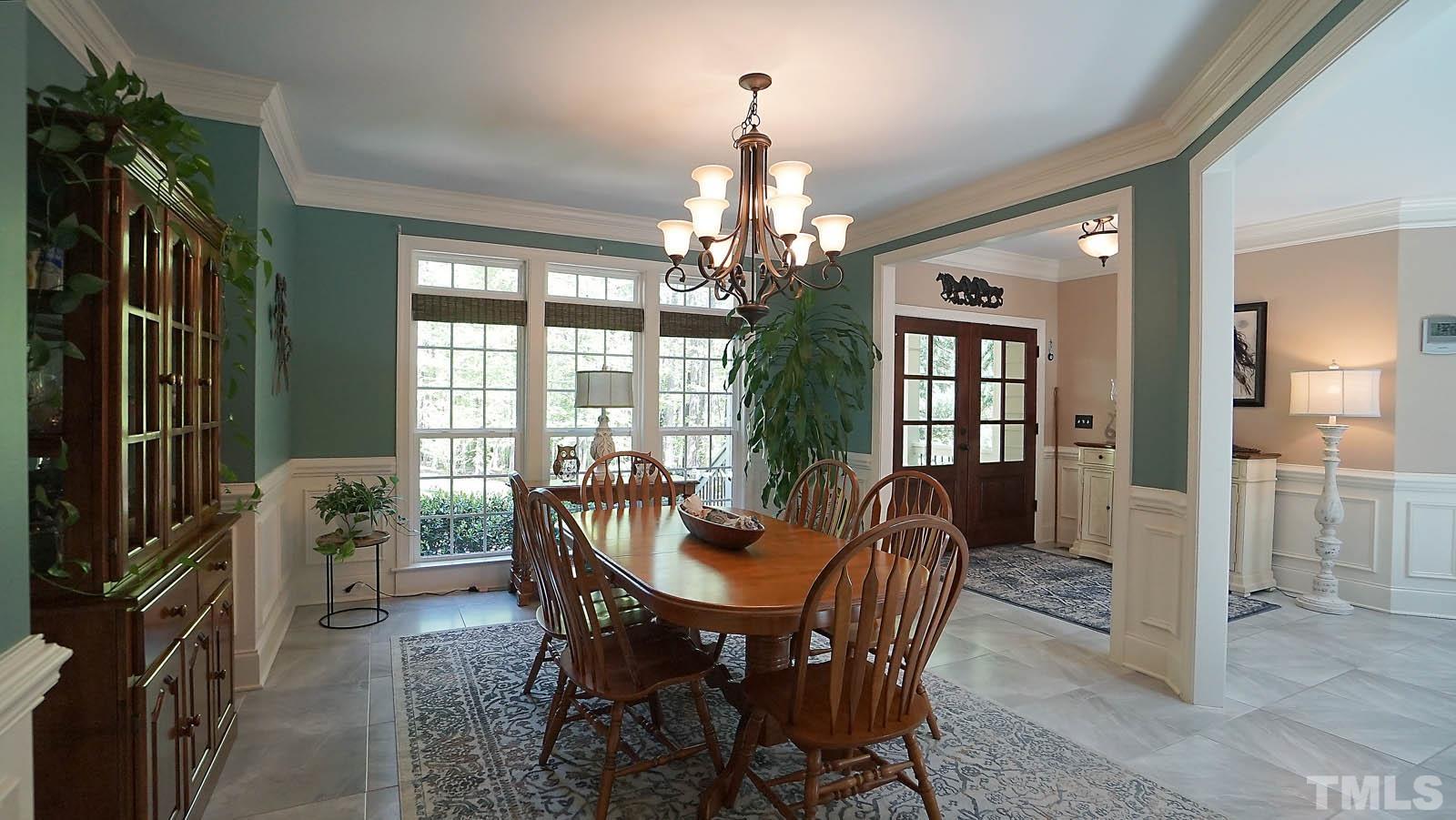 275 Hawfields Drive Pittsboro, NC 27312 - Photo 29 of 44 a dining room with furniture a chandelier and window