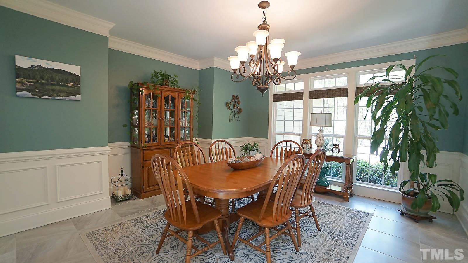 275 Hawfields Drive Pittsboro, NC 27312 - Photo 30 of 44 a view of a dining room with furniture window and wooden floor