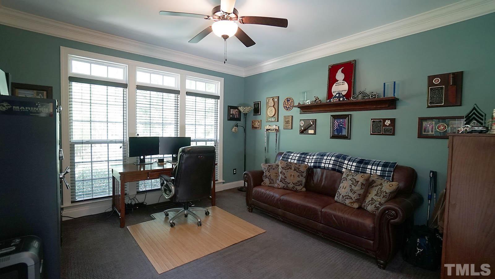 275 Hawfields Drive Pittsboro, NC 27312 - Photo 31 of 44 a living room with furniture ceiling fan and a window