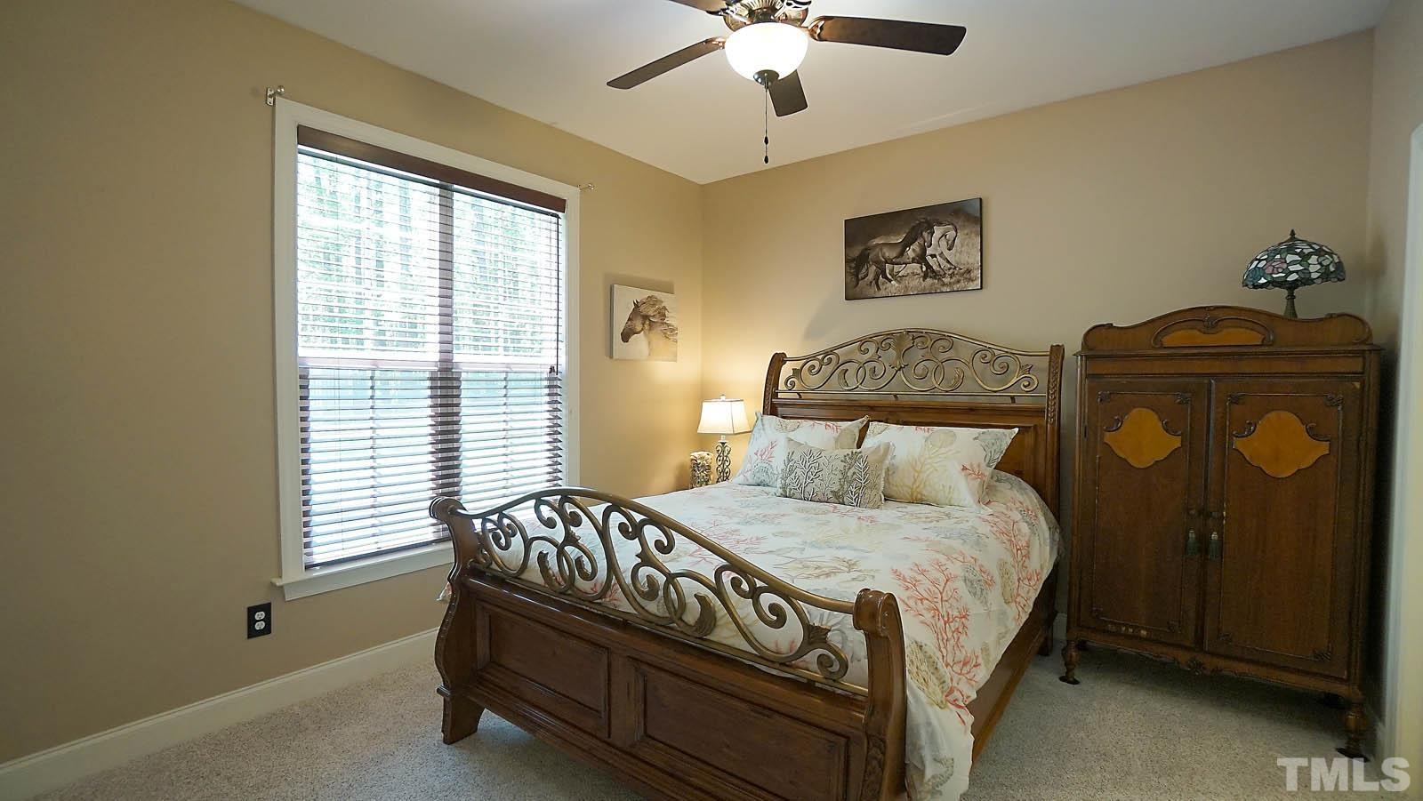 275 Hawfields Drive Pittsboro, NC 27312 - Photo 34 of 44 a bedroom with a bed and a chandelier