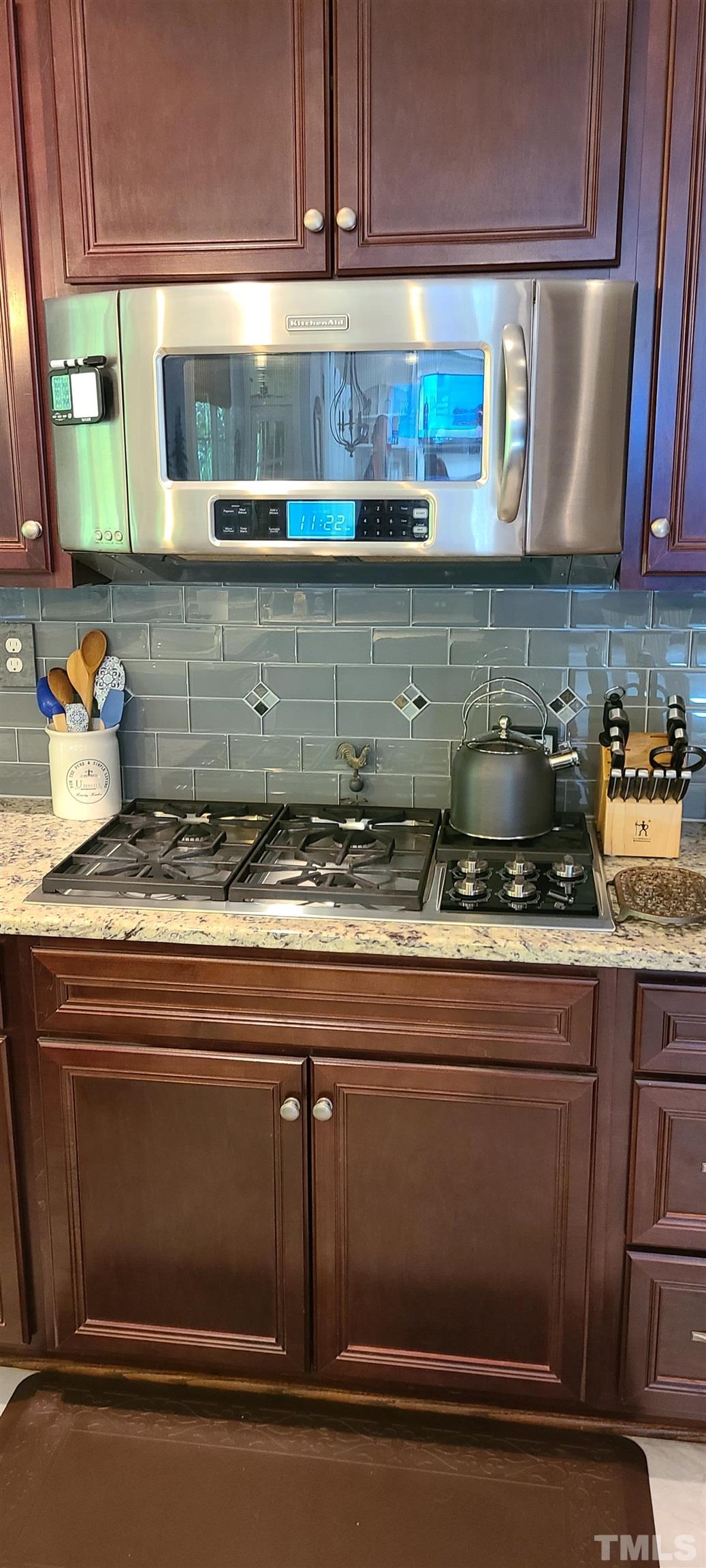 275 Hawfields Drive Pittsboro, NC 27312 - Photo 41 of 44 a kitchen with granite countertop cabinets and wooden floor