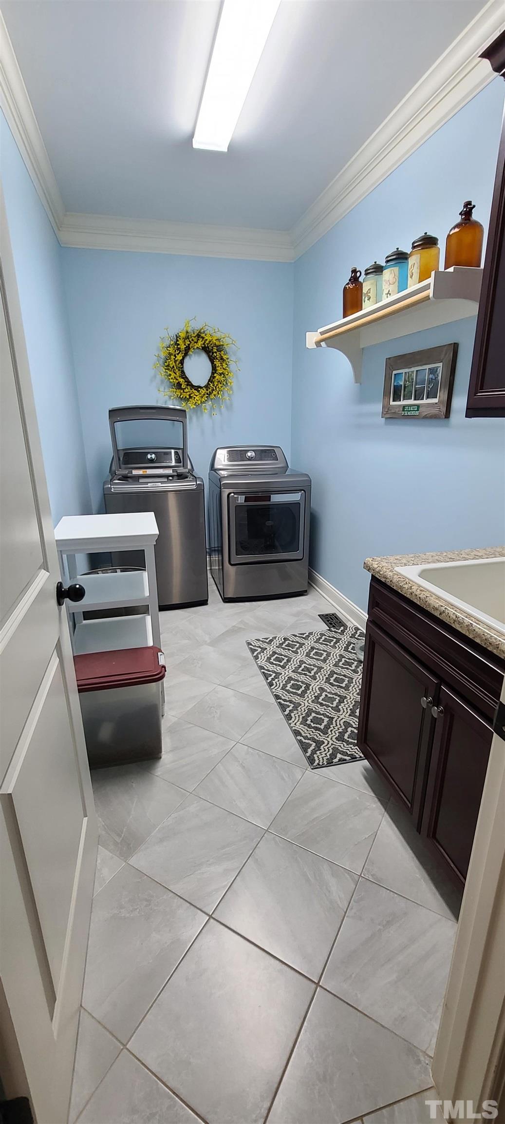 275 Hawfields Drive Pittsboro, NC 27312 - Photo 42 of 44 a kitchen with stainless steel appliances a stove a microwave and a counter top space
