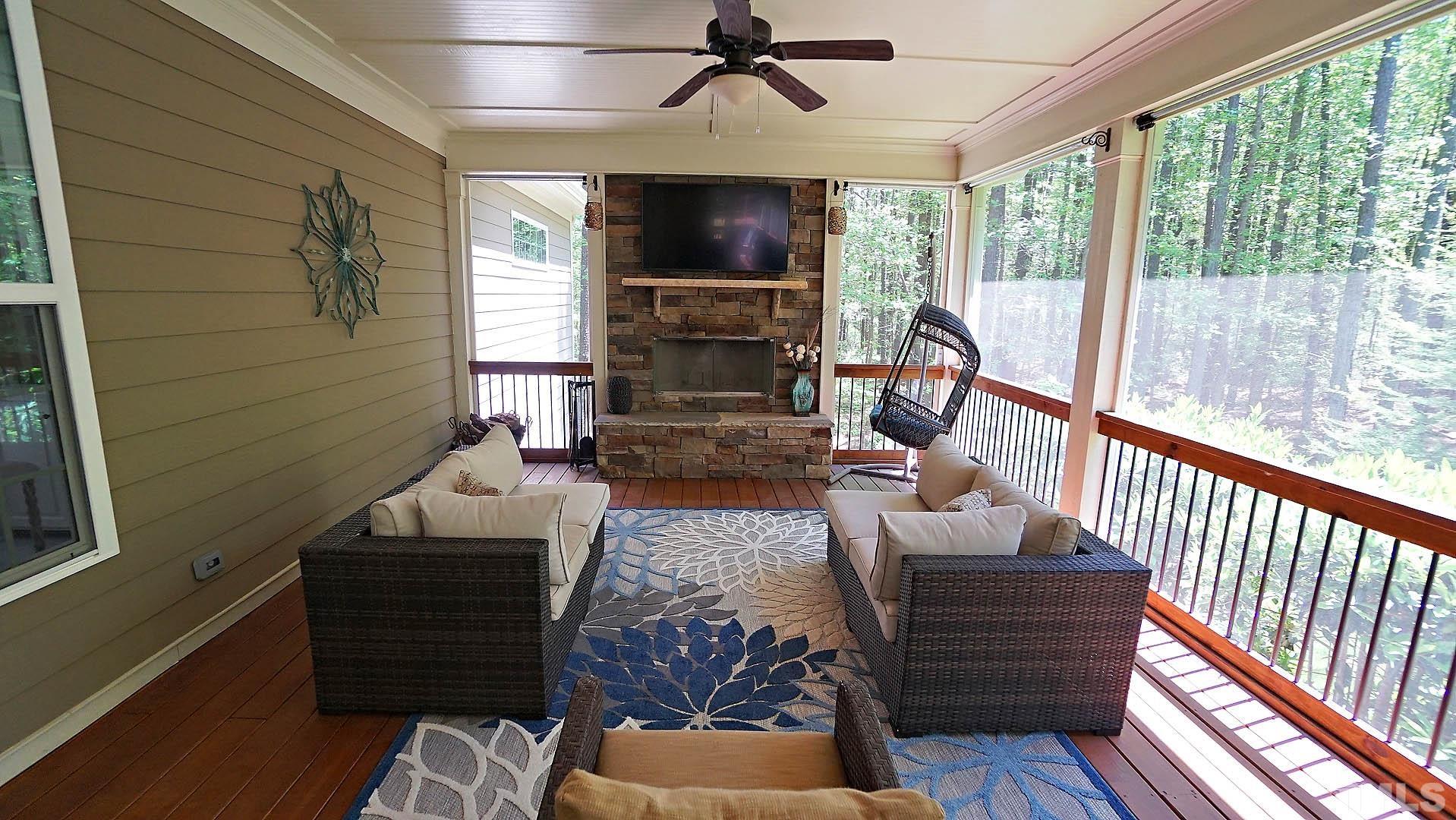 275 Hawfields Drive Pittsboro, NC 27312 - Photo 7 of 44 a living room with furniture fireplace and a flat screen tv