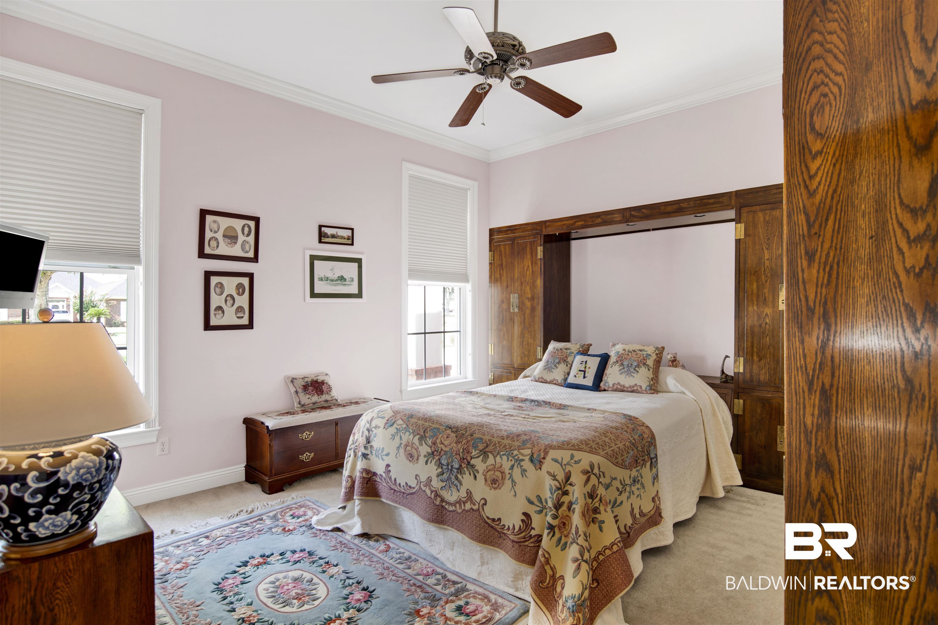 23014 Carnoustie Drive Foley, AL 36535 - Photo 16 of 49 Bedroom with crown molding, light carpet, and a ceiling fan
