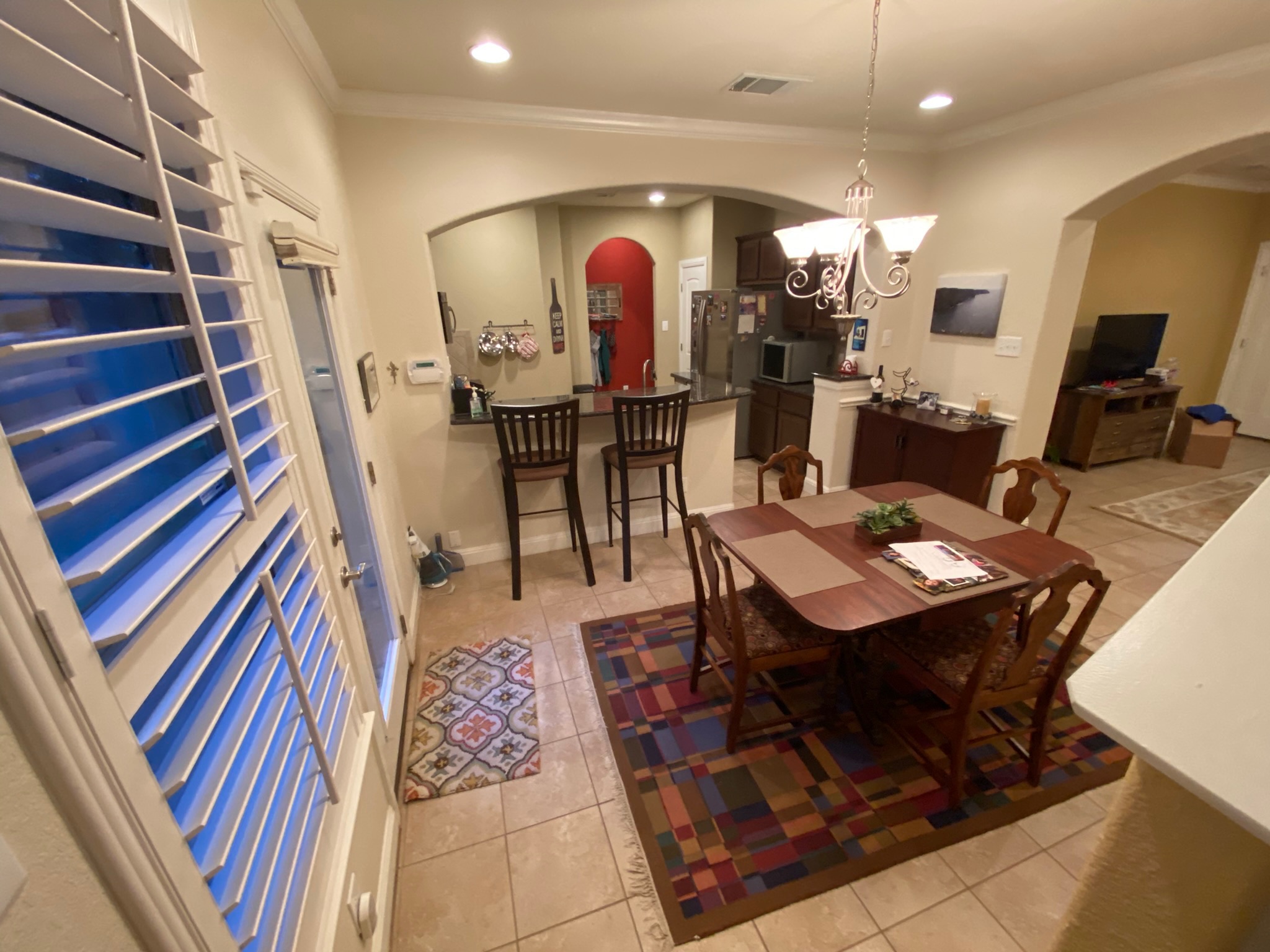 6708 Menchaca Road, Unit 25 Austin, TX 78745 - Photo 4 of 19 Tiled flooring and arched openings connect the dining space directly to the kitchen area.