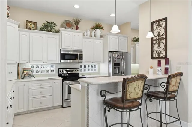 a kitchen with cabinets sink and white appliances