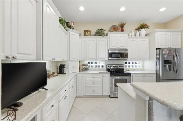a kitchen with a refrigerator and cabinets