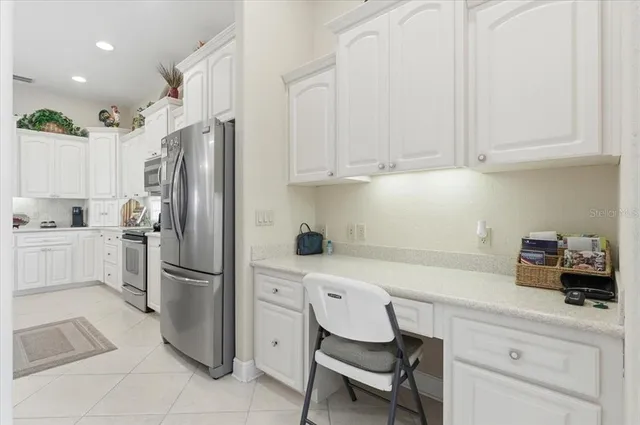 a dining room with wooden floor a chandelier a wooden table and chairs
