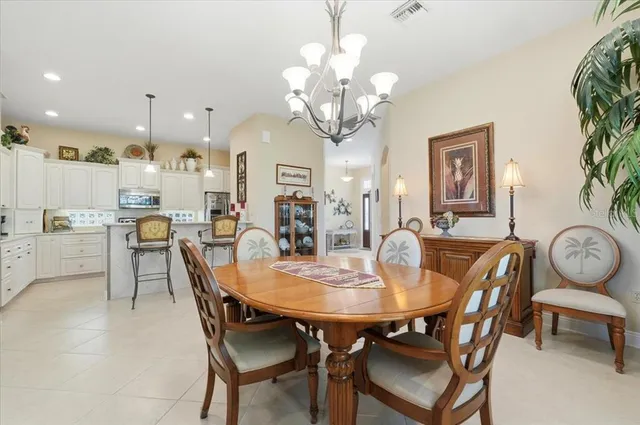 a view of a dining room with furniture and chandelier