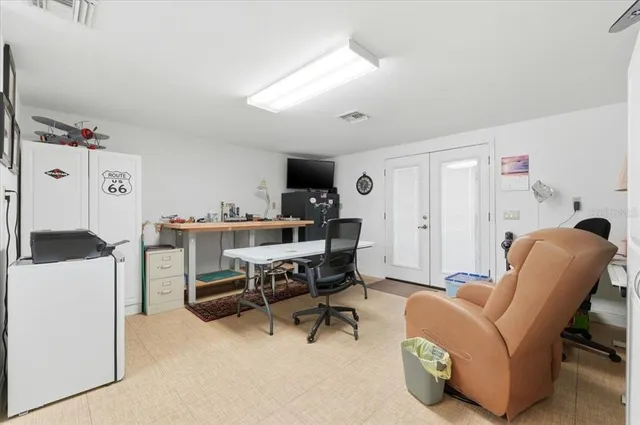 a living room with furniture a rug and white walls