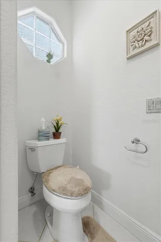 a bedroom with a bed wooden floor and window