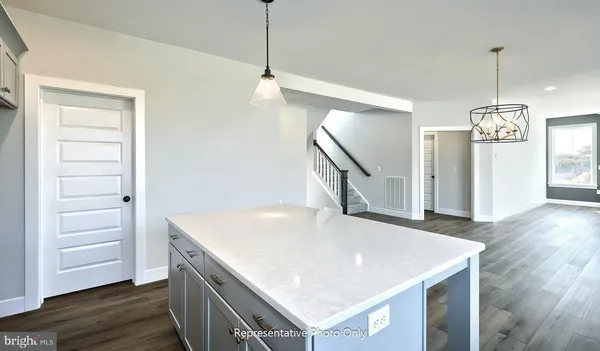 a view of a kitchen and wooden floor