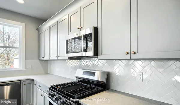 a kitchen with wooden cabinets and a stove top oven