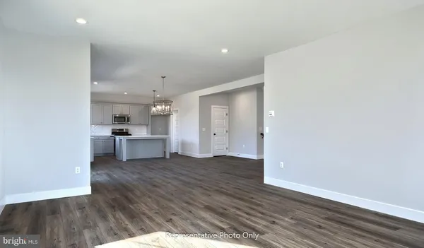 a view of a kitchen with wooden floor and a sink