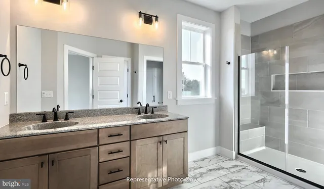 a bathroom with a shower sink and mirror