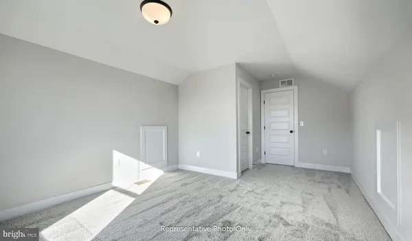 an empty room with windows and closet