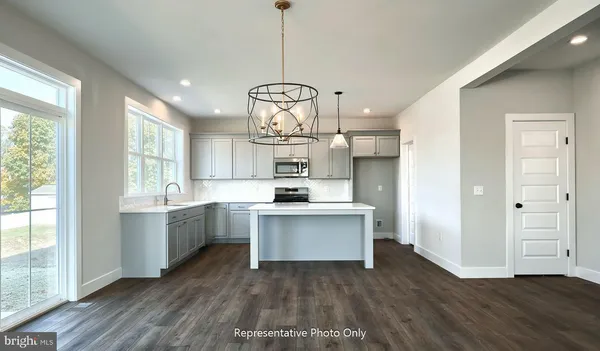 a open kitchen with sink cabinets and wooden floor