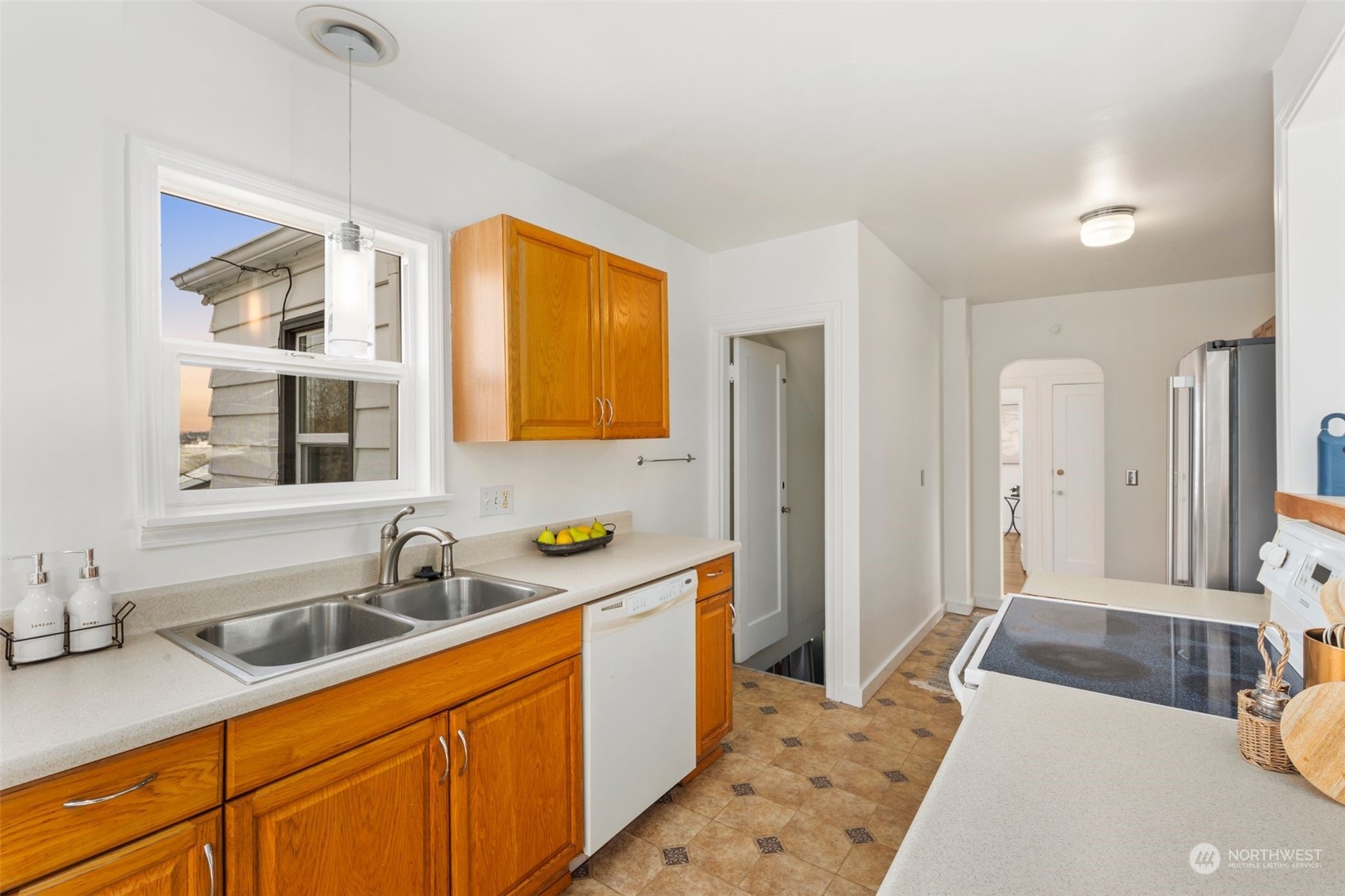 506 South 15th Street Renton, WA 98055 - Photo 10 of 28 a kitchen with a sink a refrigerator and cabinets