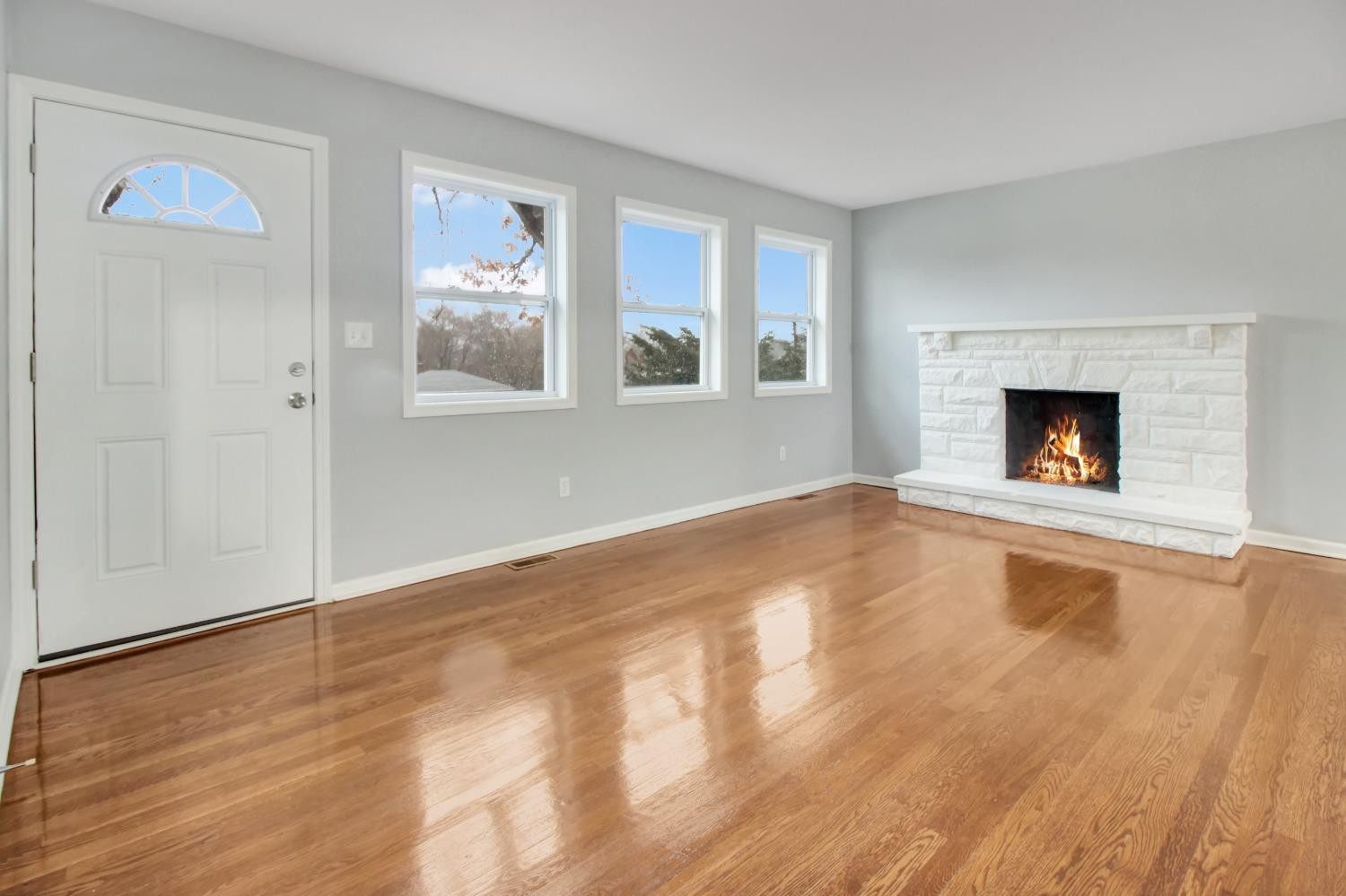 905 East Ridge Road Gary, IN 46409 - Photo 4 of 15 a view of empty room with wooden floor and fireplace