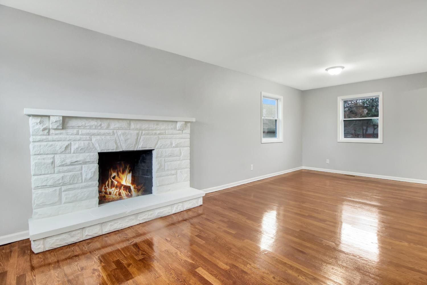 905 East Ridge Road Gary, IN 46409 - Photo 5 of 15 a view of an empty room with wooden floor fireplace and a window