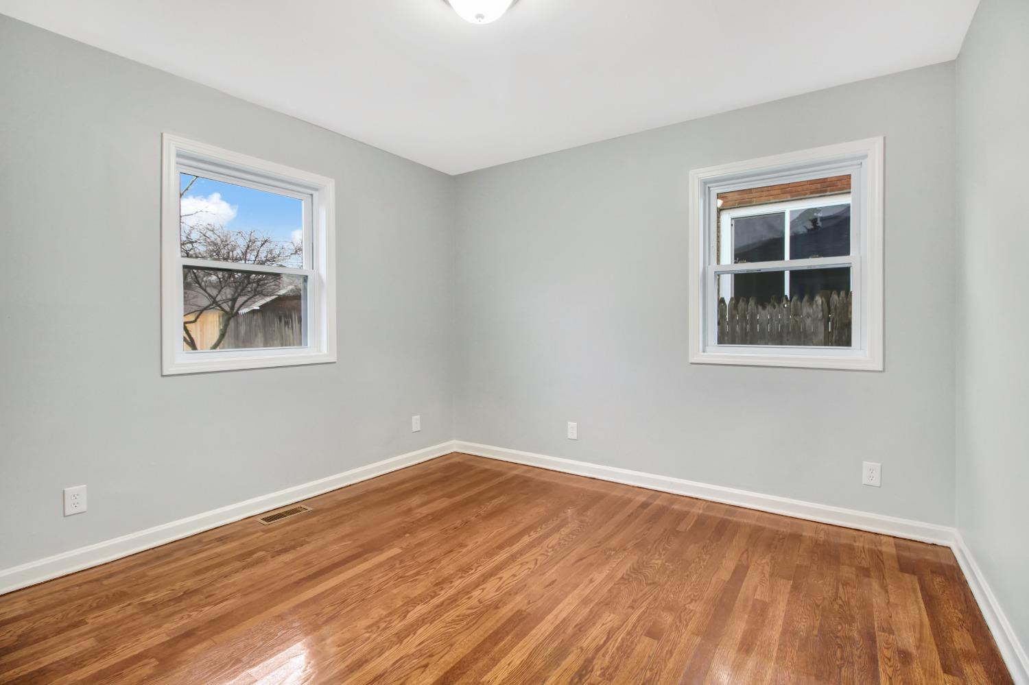 905 East Ridge Road Gary, IN 46409 - Photo 7 of 15 a view of an empty room with wooden floor and a window