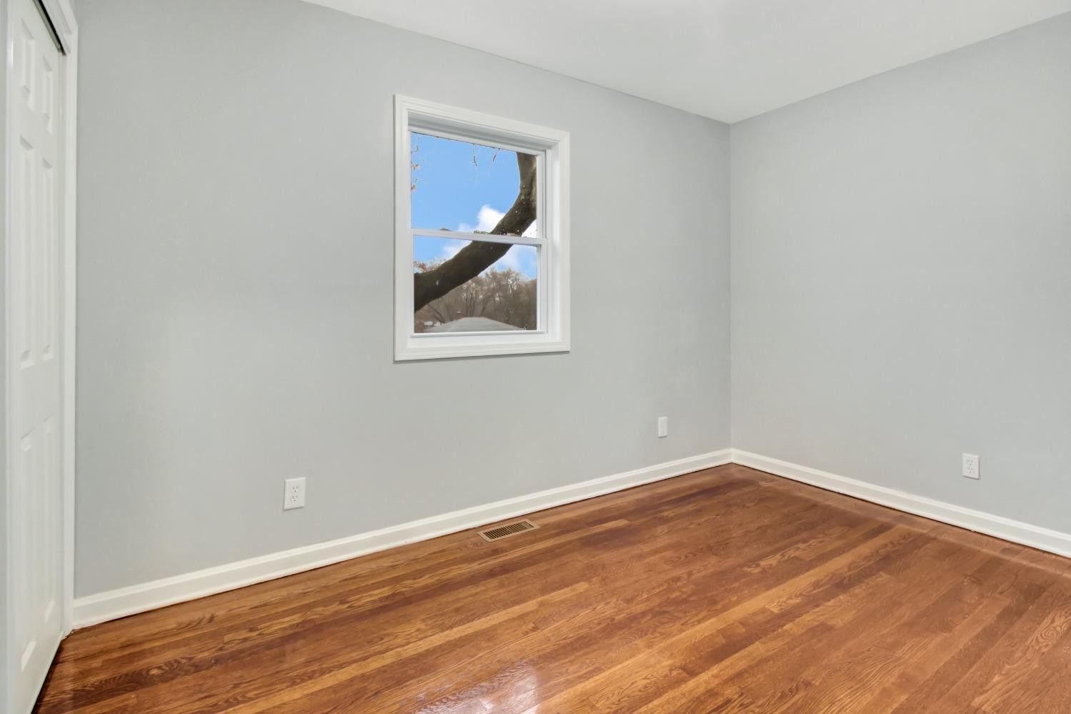 905 East Ridge Road Gary, IN 46409 - Photo 9 of 15 an empty room with wooden floor and window