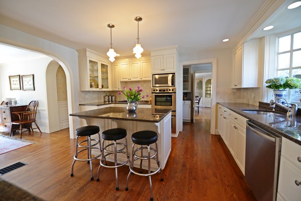 47 Carisbrooke Road Wellesley, MA 02481 - Photo 8 of 24 a large kitchen with granite countertop stools a sink a counter space and stainless steel appliances