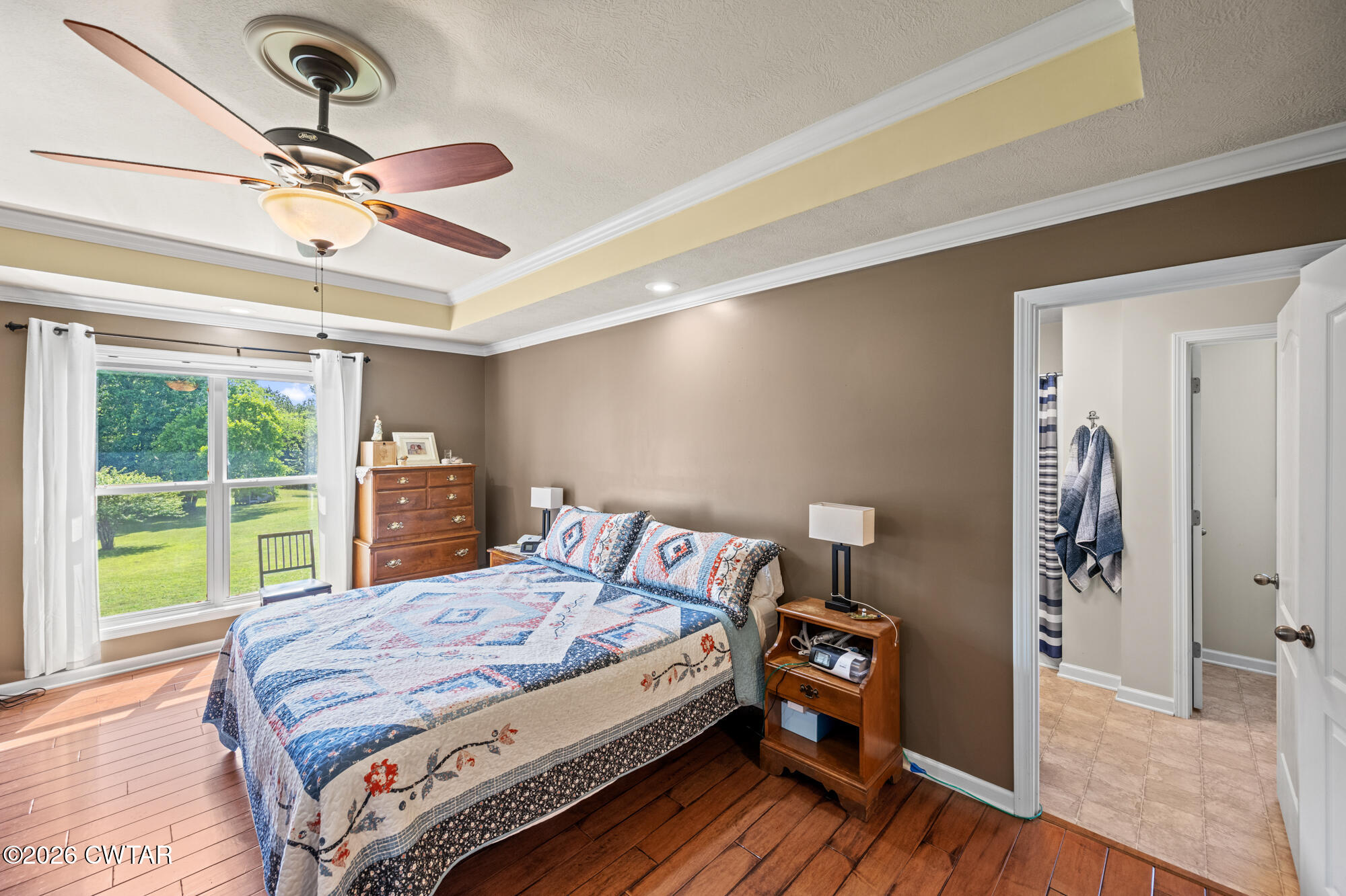 492 Joe Horton Road Lexington, TN 38351 - Photo 19 of 49 a bedroom with a bed and a chandelier