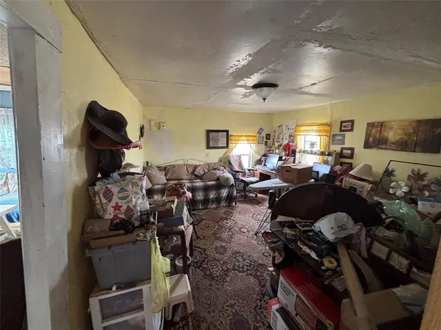 a living room with lots of furniture and gym equipment