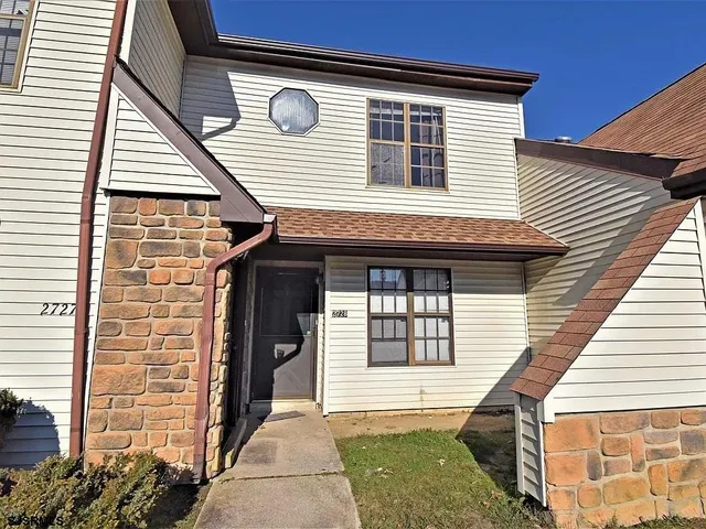 a front view of a house with a garage