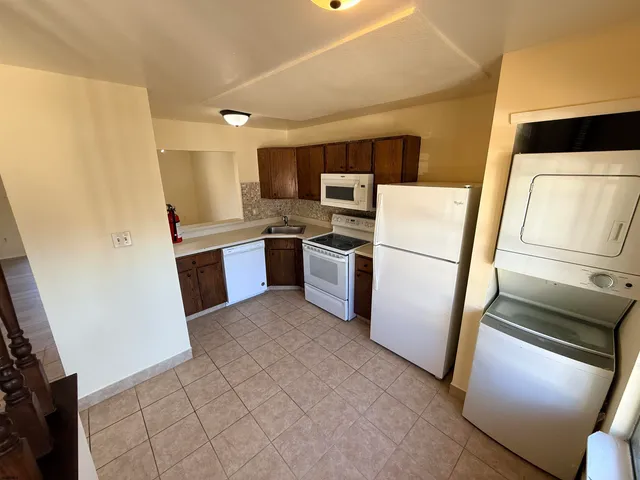 a kitchen with stainless steel appliances a refrigerator and a stove top oven