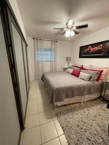 a bedroom with a bed and a large mirror