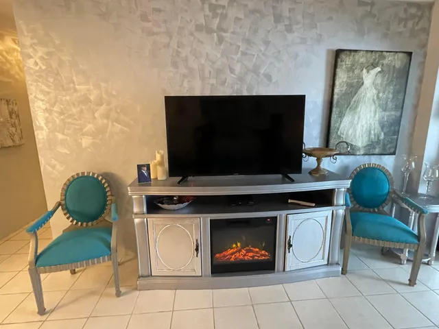 a living room with a fireplace and a flat screen tv