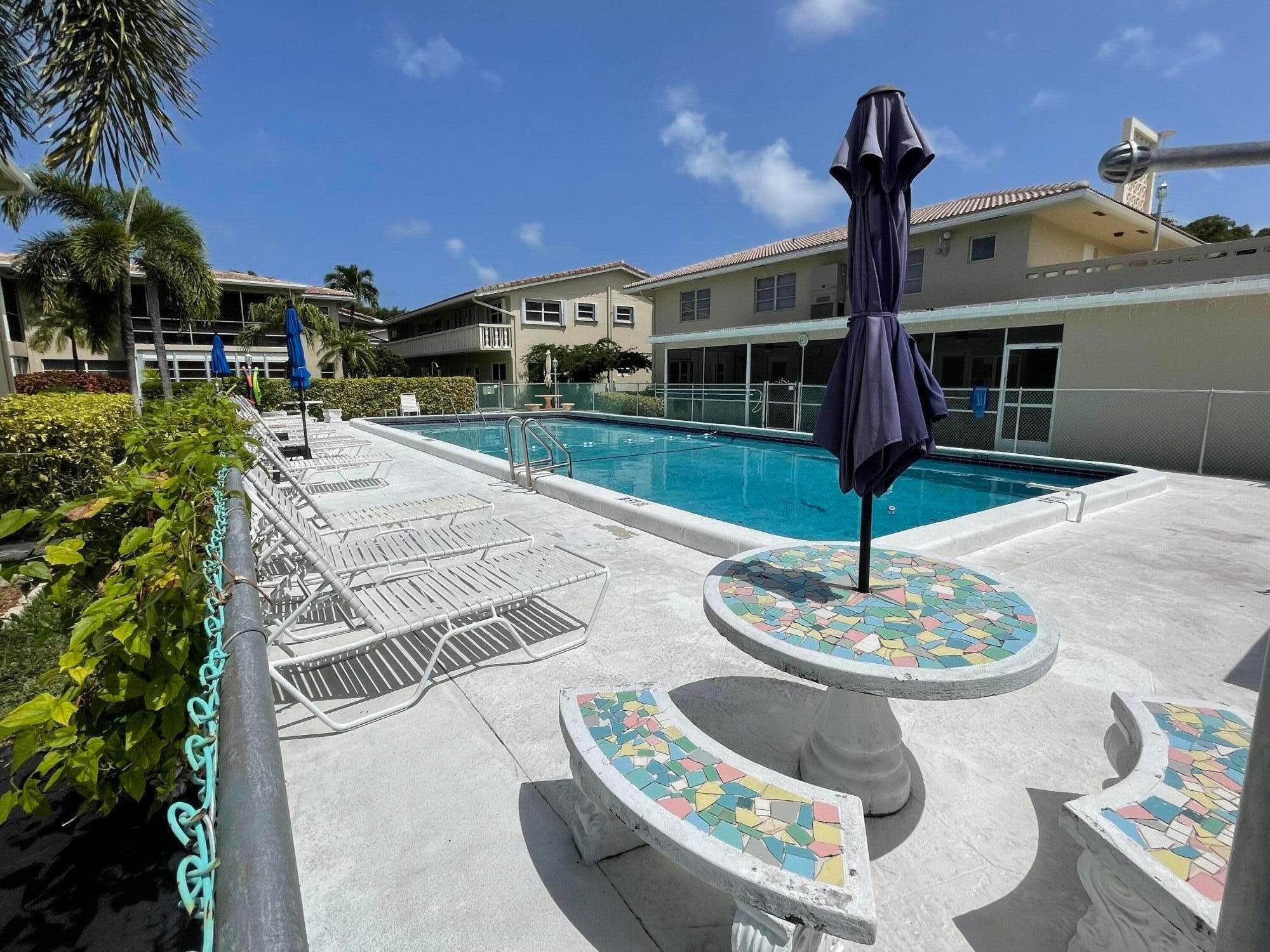 2131 Northeast 42nd Court, Unit 210E Lighthouse Point, FL 33064 - Photo 19 of 22 a front view of a house with garden